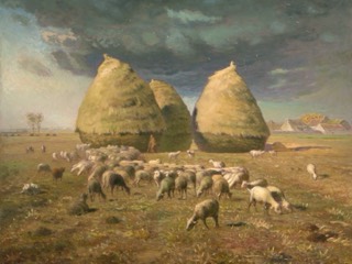 Three tall haystacks in a harvested field, with a flock of sheep grazing in front, under a dark cloudy sky.