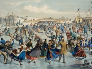 Crowds of skaters in colorful winter coats on a frozen lake in Central Park, with a bridge, a flag-topped building and bare trees behind.