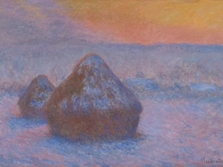 Two snow-covered wheat stacks in a field at sunset, under a pink and orange sky, with blue shadows on the snow.